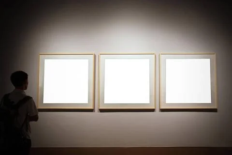Empty exhibition frames and person looking walls in museum with empty fram... Stock Photos