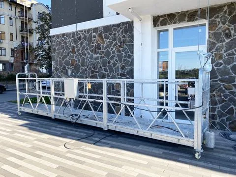 An empty facade elevator against the backdrop of damaged buildings after the war Stock Photos