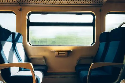 Empty facing seats inside a quiet train compartment. Concept of public tran.. Fotos Stock