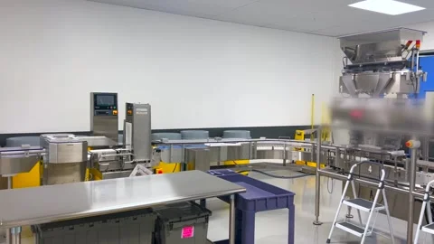 Empty factory workspace with idle machinery reflecting labor shortage. Conveyor Stock-Footage 301521596
