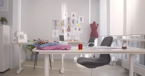 Empty fashion design studio with clothes, sewing machine and various sketches Stock Footage 154134226
