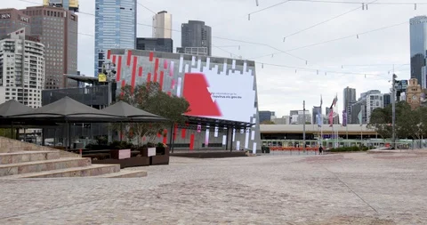 Empty Federation Square and Coronavirus Sign During Coronavirus Shutdown Stock Footage 130155696