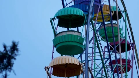 An empty ferris wheel slowly spinning in the dusk Stock Footage 145192883