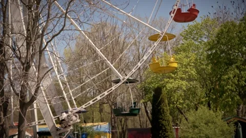 Empty Ferris Wheel Spinning in Spring Amusement Park Under Blue Sky Stock Footage 339072804