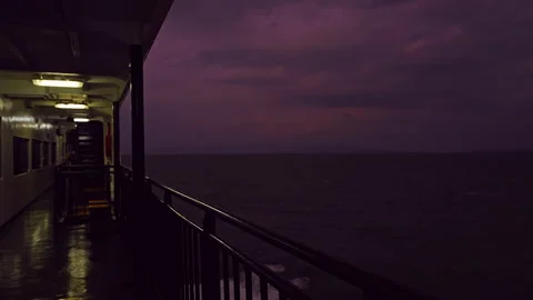 Empty Ferry Side Deck With Metal Railing Wet Floor And Open Sea Under Dark Purpl Video stock 328408270
