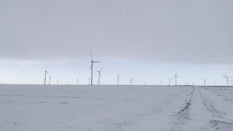 Empty fields and wind turbine. Snowy winter rural landscape Stock Footage 325991917