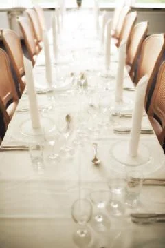 Empty fine dining room table arranged for dinner in fancy restaurant. Above view Stock Photos