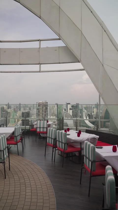 Empty Fine Dining Tables Set with Red Glassware on Rooftop Restaurant Stock Footage 336220147