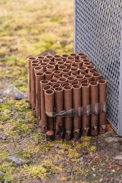 Empty firework tubes arranged on ground. Stock Photos