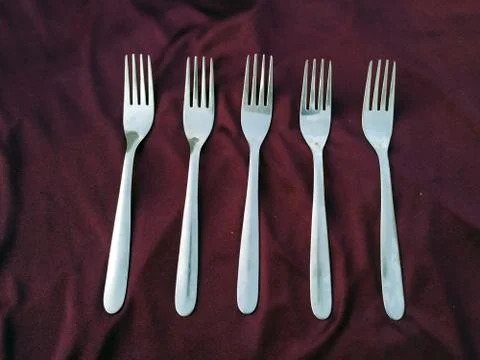 Empty five Steel Fork isolated on violet background Stock Photos