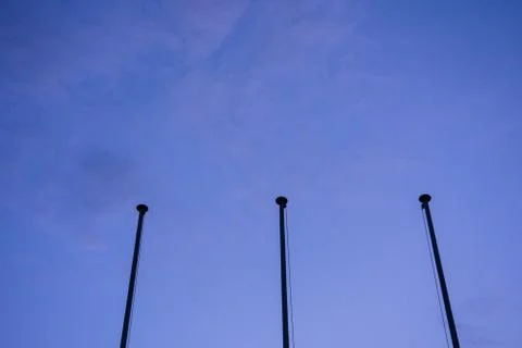 Empty flag post low angle view in blue hour night abstract architecture Stock Photos
