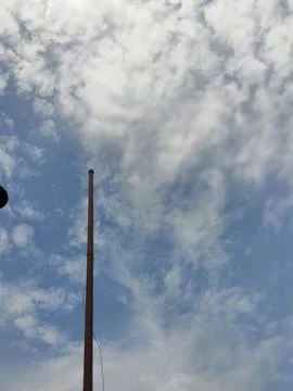 Empty Flagpole Against a Cloudy Sky Stock Photos