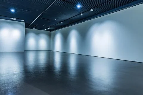 Empty floor and white wall under the light. Stock Photos