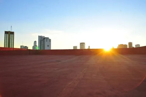 Empty floor platform with sunset  view city skyline background Stock Photos