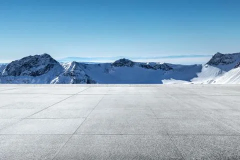 Empty  floor with snow mountains on background Stock Photos