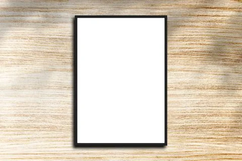 Empty frame. Blank dark grey mounted landscape frame on white wood Stock Photos