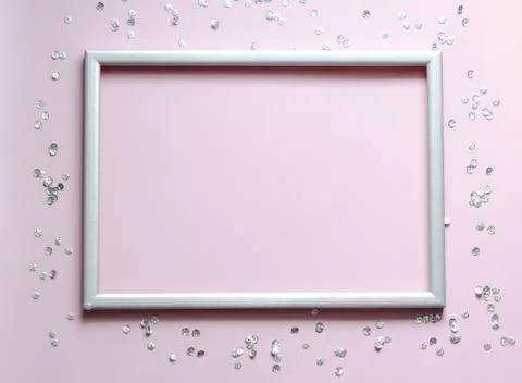 Empty frame with the confetti and space for text on pink background. Stock Photos