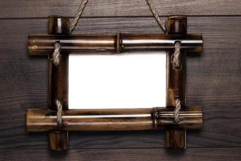 Empty frame with copy space hanging on wooden wall Stock Photos