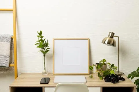 Empty frame with copy space, plants, technology devices on table against white Stock Photos