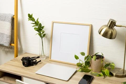 Empty frame with copy space, plants, technology devices on table against white Stock Photos