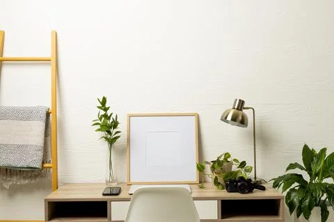 Empty frame with copy space, plants, technology devices on table against white Stock Photos