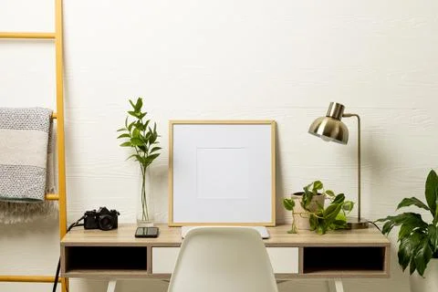 Empty frame with copy space, plants, technology devices on table against white Stock Photos