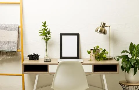 Empty frame with copy space, plants, technology devices on table against white Stock Photos