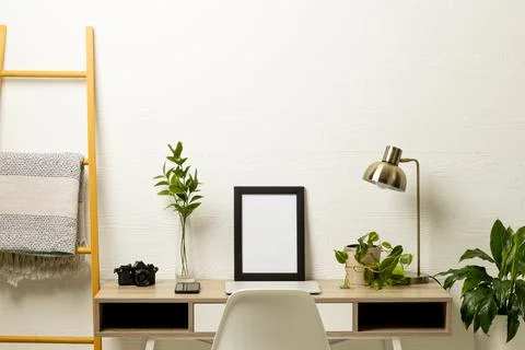 Empty frame with copy space, plants, technology devices on table against white Stock Photos