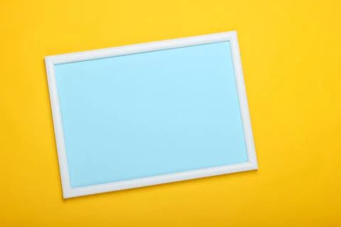 Empty frame for copy space on a yellow background. Pastel color trend, minima Stock Photos
