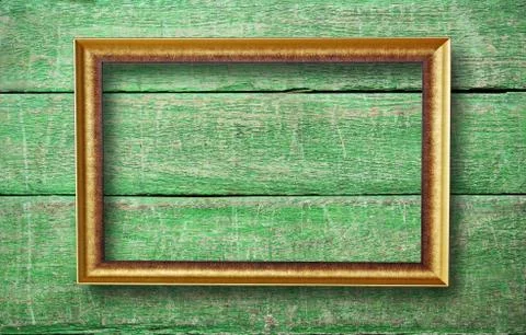 Empty frame with copyspace hanging on creative green wooden background Stock Photos