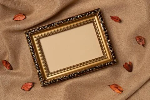 Empty frame with foliage on a fabric background from above. Autumn concept. Stock Photos