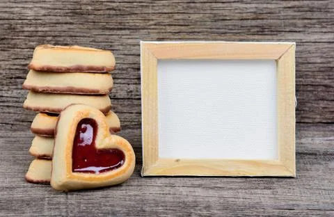 Empty frame with heart cookies on table Stock Photos