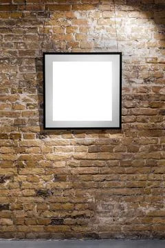 Empty frame on light brick wall. Blank space poster or art frame waiting to b Stock Photos