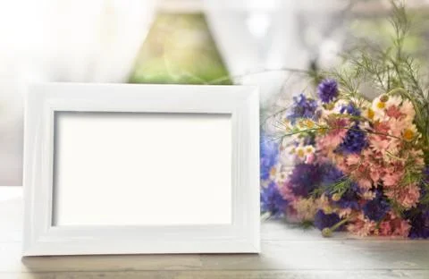 Empty frame mockup and flowers Stock Photos