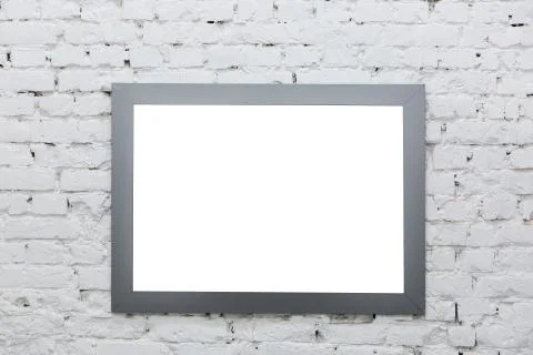 Empty frame from a painting on a white brick wall. White place mock up Stock Photos