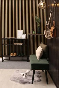 Empty frames and green branches on console table in hallway 스톡 사진