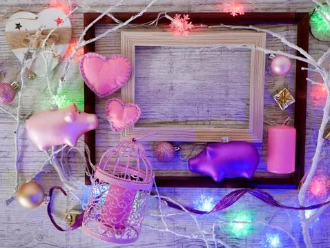 Empty frames, Christmas decor, a pair of pigs, felt hearts, candles Stock Photos