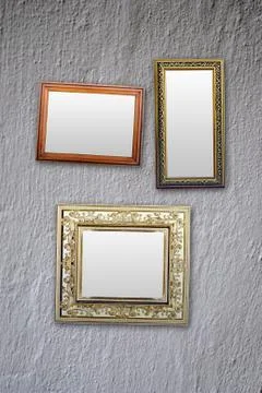 Empty frames for photos hanging on the white wall Stock Photos