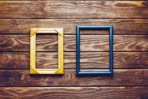 Empty frames on a wooden background. Stock Photos