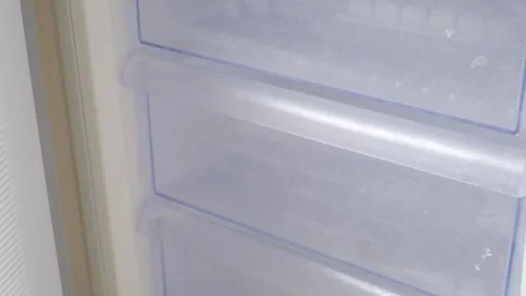 Empty freezer with plastic drawers close-up front view. Stock Footage 306278041
