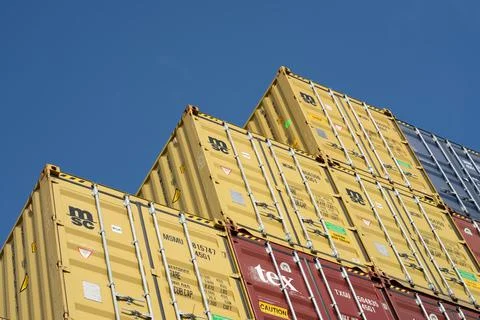 Empty Freight containers stacked high in storage yard Stock Photos