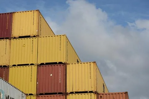Empty Freight containers stacked high in storage yard Stock Photos