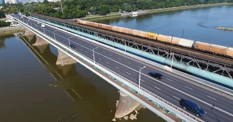 Empty Freight Train Moving On A Bridge On Sunny Day. Aerial View Stock Footage 93339652
