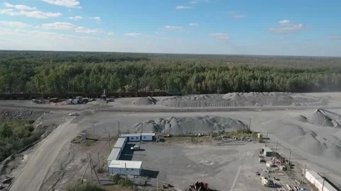 Empty freight train rides past an industrial area Stock Footage 202062841