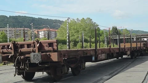 Empty freight train wagons passing on a sunny day Stock Footage 332649550