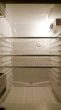 Empty fridge interior, frontal view Stock Photos