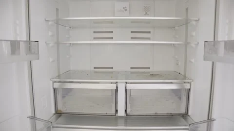 Empty fridge with no food items and dirty shelves with old leftover liquids Stock Footage 313904332