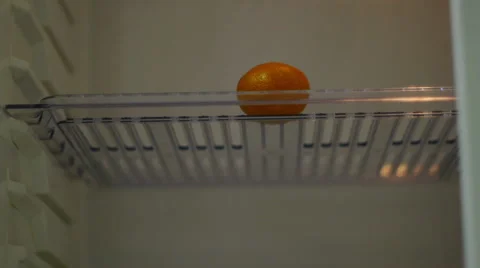 Empty Fridge With A Tangerine Stock Footage 57356663