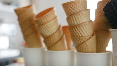 Empty fried waffle cones are stacked in each other. Real time, indoors, day, clo Stock Footage 93514533