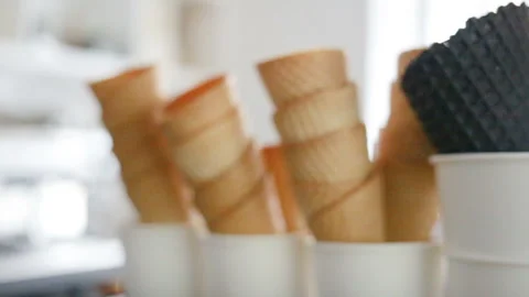 Empty fried waffle cones are stacked in each other. Real time, indoors, day, clo Stock Footage 93514603